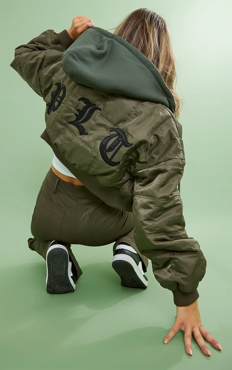 PRETTYLITTLETHING Khaki Slogan Back Jersey Hooded Bomber Jacket 1 PRETTYLITTLETHING Khaki Slogan Back Jersey Hooded Bomber Jacket