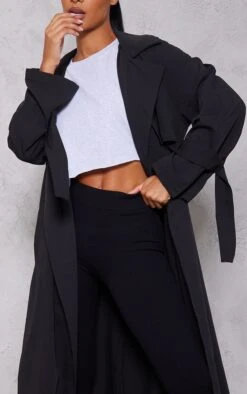 Black Drapey Woven Longline Trench -Modern Wear Boutique 5bfdcef437526fb1d99f2f6f9b693cfe8689eb25 cna9695 4