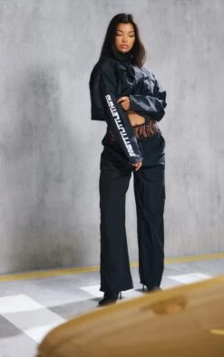 PRETTYLITTLETHING Black Slogan Boxy Cropped Windbreaker Jacket